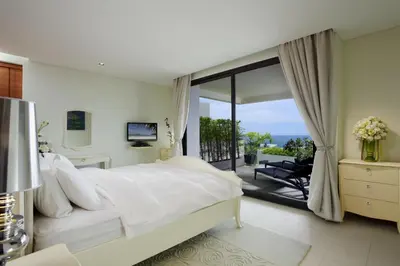 a bedroom with a large white bed and a balcony at The heights B18 Seaview near Kata Beach in Kata Beach
