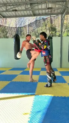 two men in a boxing match in a gym at At Thara Aonang in Ao Nang Beach