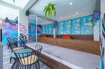 a bar with chairs and tables in a room at Kana Triple L Hotel Phuket\u666e\u5409\u5c9b\u5361\u5a1c3L\u9152\u5e97 in Patong Beach