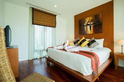 a bedroom with a bed with two stuffed animals on it at Ocean views Kata gardens penthouse 6C near Kata Noi Beach in Kata Beach