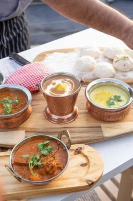a table topped with bowls of food on a table at SKYVIEW Resort Phuket Patong Beach in Patong Beach