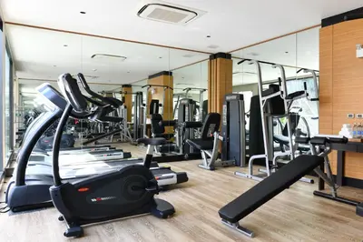 a gym with a lot of treadmills and ellipticals at SKYVIEW Resort Phuket Patong Beach in Patong Beach
