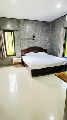 a bedroom with a large bed in a room at Green Mountain Resort Koh Yao in Ko Yao Yai