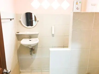 a small bathroom with a sink and a mirror at Discovery House Hotel SHA Plus in Nai Yang Beach