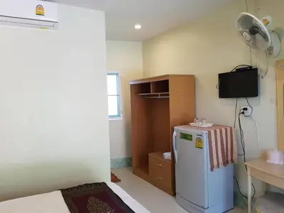 a small kitchen with a refrigerator and a fan at Discovery House Hotel SHA Plus in Nai Yang Beach