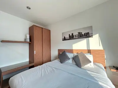 a bedroom with a bed with white sheets and pillows at Clear House Resort - SHA Extra Plus in Kamala Beach
