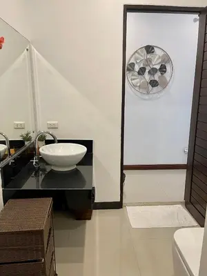 a bathroom with a sink and a mirror at Villa Suksan - Kubu in Nai Harn Beach