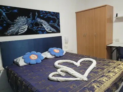 a bed with a heart made out of towels at B&B NAMO PHUKET in Kathu