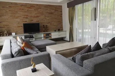 a living room with two couches and a television at 4 Bedroom Villa Kamala Beach Phuket in Kamala Beach