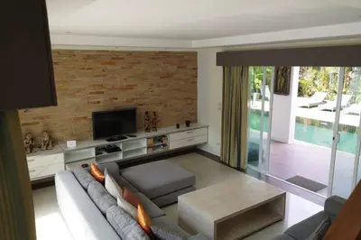 a living room with a couch and a tv at 4 Bedroom Villa Kamala Beach Phuket in Kamala Beach