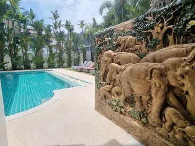 a wall with elephant statues next to a swimming pool at 4 Bedroom Villa Kamala Beach Phuket in Kamala Beach