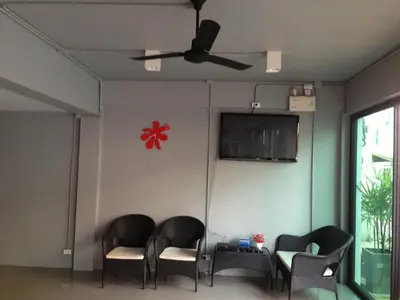 a room with four chairs and a flat screen tv at Chalong Sea Breeze in Chalong