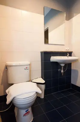 a bathroom with a toilet and a sink at Chalong Sea Breeze in Chalong