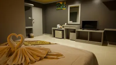 a bedroom with a large bed with a swan on it at The Little Moon Residence in Patong Beach