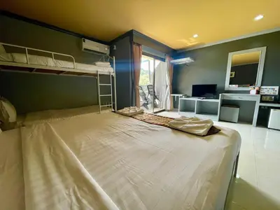 a bedroom with two bunk beds and a living room at The Little Moon Residence in Patong Beach