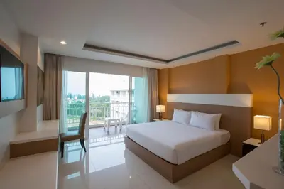 a hotel room with a bed and a balcony at Chanalai Hillside Resort, Karon Beach in Karon Beach