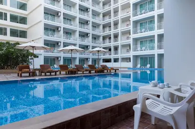 a swimming pool in front of a building at Chanalai Hillside Resort, Karon Beach in Karon Beach