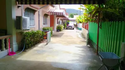 an alley with a car driving down a street at Bangtao Kitchen Studio in Bang Tao Beach