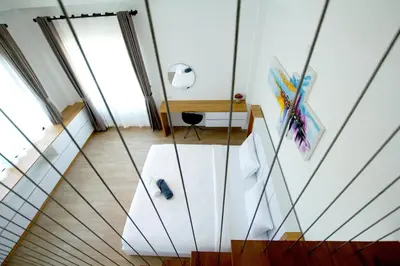 a room with a staircase with glass walls at Happy Family Villa in Phuket Town