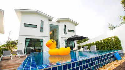 a rubber duck sits on the edge of a swimming pool at Happy Family Villa in Phuket Town