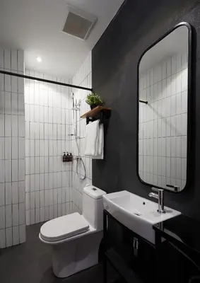 a bathroom with a toilet and a sink and a mirror at P2 Wood Loft in Phi Phi Don
