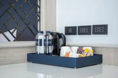a blue tray with bottles of water and other items at Seabed Grand Hotel Phuket in Phuket Town