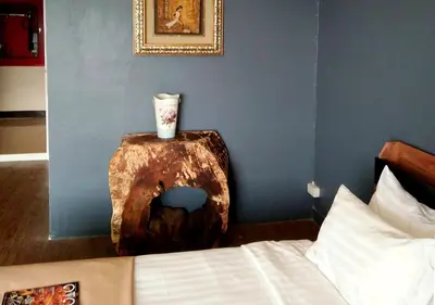 a bedroom with a bed and a table with a vase on it at Studio Sea View Patong in Patong Beach