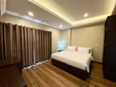 a bedroom with a large white bed and curtains at Blue Aura Pool Villa in Nai Yang Beach