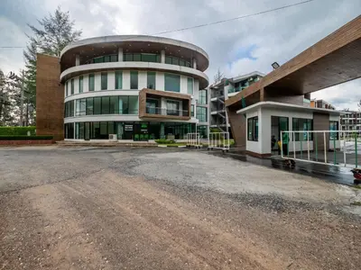 an empty parking lot in front of a building at Naithon Beachfront Condotel in Nai Thon Beach
