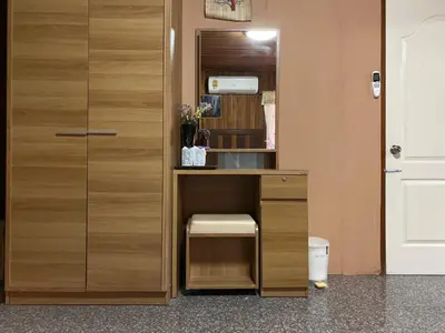 a room with a desk and a door with a stool at Yuwadee Resort in Chalong