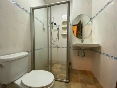 a bathroom with a shower and a toilet and a sink at Yuwadee Resort in Chalong