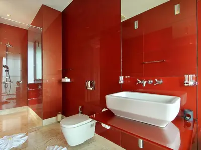 a red bathroom with a toilet and a sink at Villa Minh in Kamala Beach