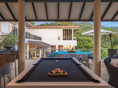 a pool table on a patio with a table with a pool at Katamanda - Villa Amanzi by Elite Havens in Kata Beach