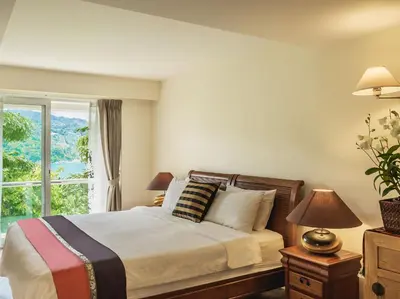 a bedroom with a large bed and a window at Katamanda - Villa Amanzi by Elite Havens in Kata Beach