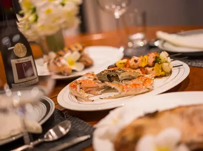 a wooden table with plates of food on it at Katamanda - Villa Amanzi by Elite Havens in Kata Beach