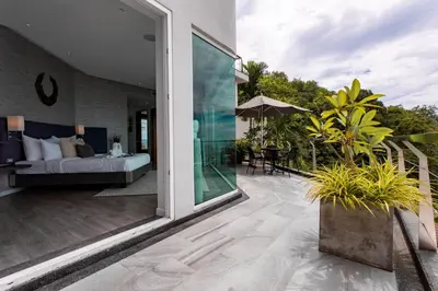 a room with a bed and a patio at Villa Namaste 7 Bedroom Fully Staffed Seaview Villa in Bang Tao Beach