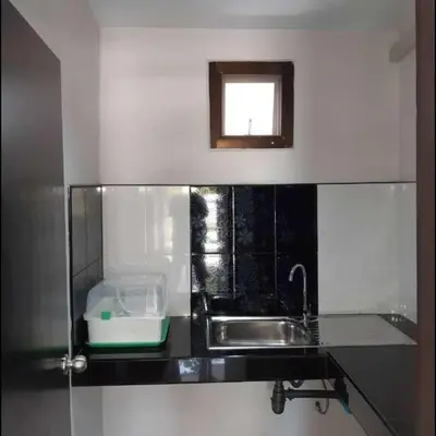 a kitchen counter with a sink and a window at Teahouse in Phuket Town
