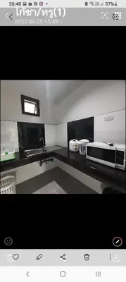 a kitchen with a sink and a microwave at Teahouse in Phuket Town