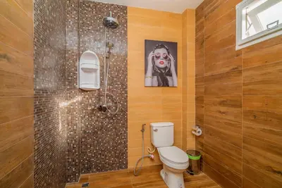 a bathroom with a toilet and a shower at Phuket9 Residence in Chalong