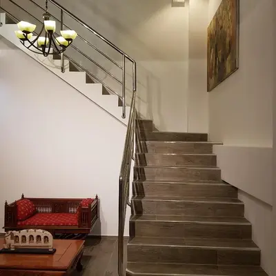 a staircase with a red couch and a stair case at Austrian Garden Hotel & Restaurant Patong in Patong Beach