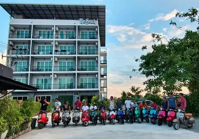 a group of people on scooters in front of a building at The Beach at Klong Muang in Klong Muang Beach