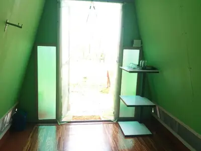a green room with a door and a window at ฺBankunyaiy Resort in Ko Yao Yai
