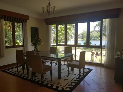a dining room with a glass table and chairs at laguna waters \u60a6\u6995\u5e84 \u62c9\u53e4\u7eb3 in Bang Tao Beach