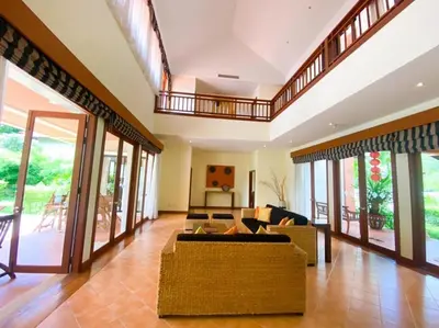a large living room with a couch and a balcony at laguna waters \u60a6\u6995\u5e84 \u62c9\u53e4\u7eb3 in Bang Tao Beach