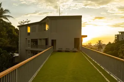 a balcony of a house with a lawn at Palmetto by Holy Cow, 2-BR, jungle view in Karon Beach