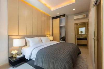 a bedroom with a large bed in a room at Palmetto by Holy Cow, 2-BR, jungle view in Karon Beach