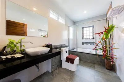 a bathroom with a sink and a toilet and a mirror at Irawan House in Ao Nang Beach