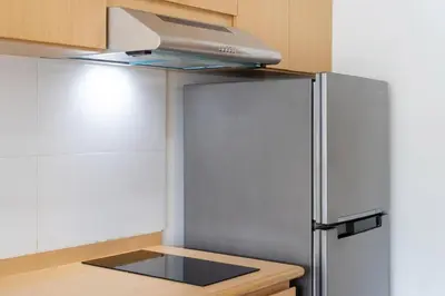 a kitchen with a stainless steel refrigerator with a hood at Ozone Kata -Great location, rooftop pool, convenient studio in Karon Beach