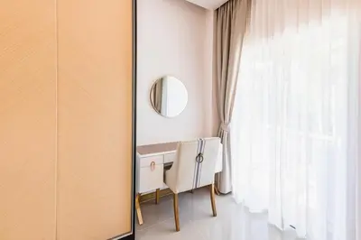 a dressing table in a room with a window at Palmetto Condominium in Karon Beach