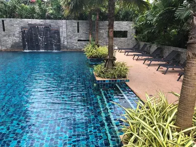 a swimming pool with chairs and a water fountain at Relife Windy by Nataly in Phuket Town